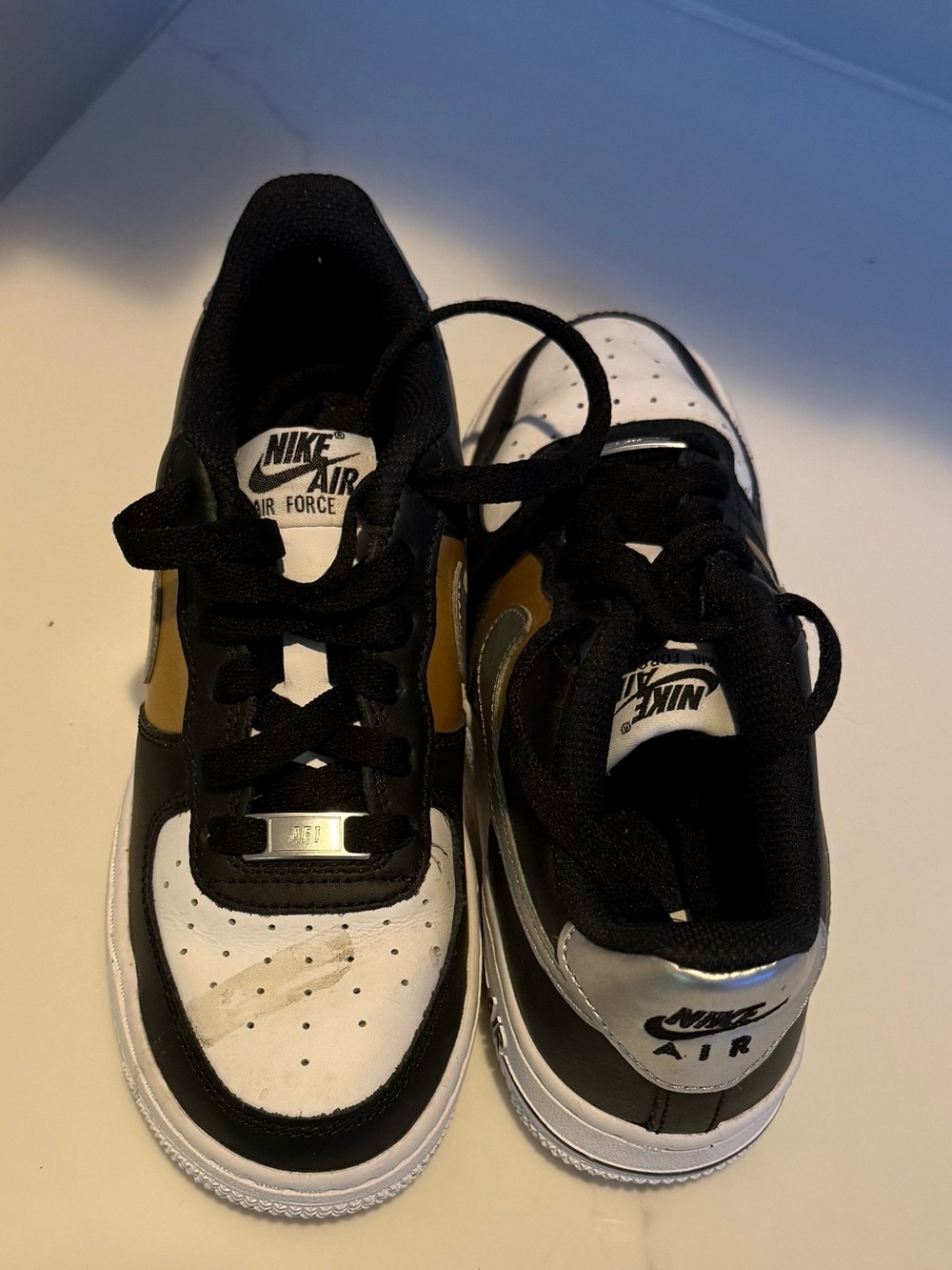 Nike Kids Sneakers in Black, White & Gold Accent